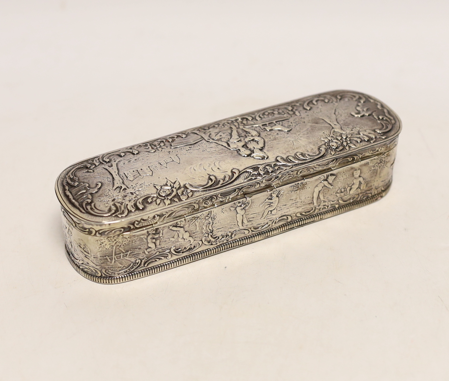 A late 19th/early 20th century Hanau repousse white metal oval box, with hinged cover, 18cm, 7.2oz.